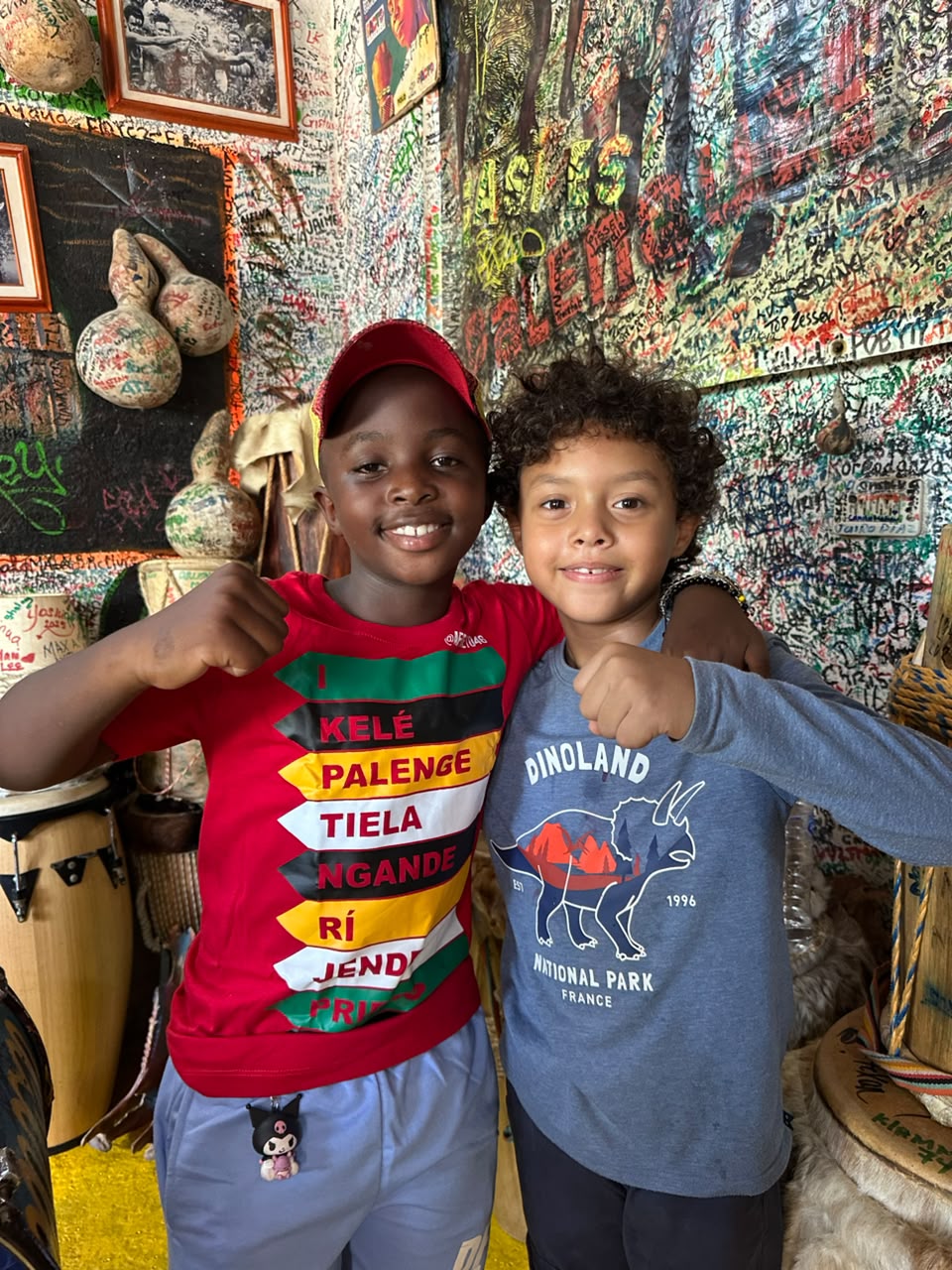 Young Prince with a friend, smiling with drums nearby