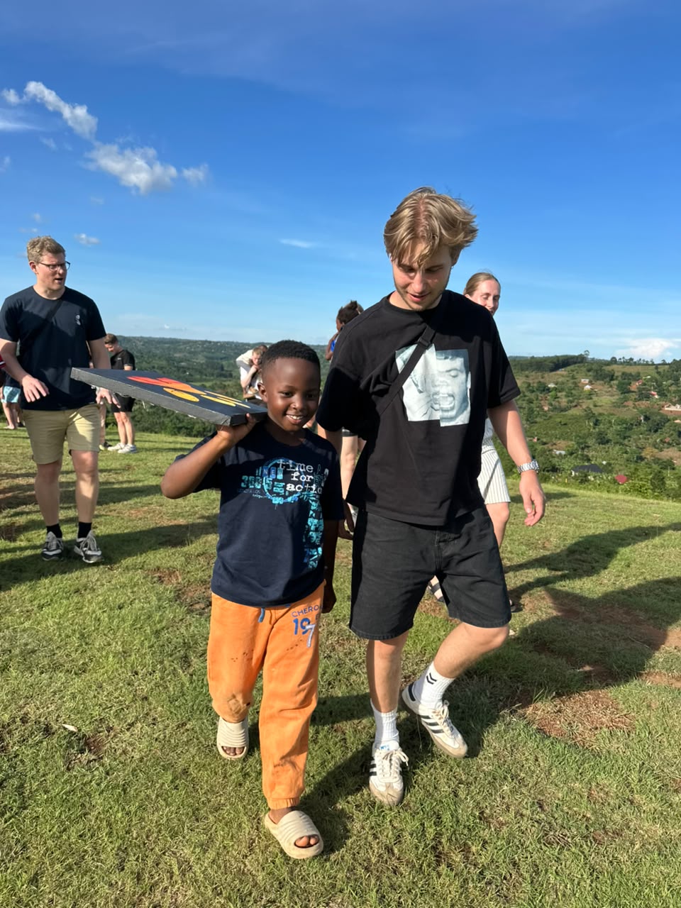 Prince walking on a green hillside with a mentor