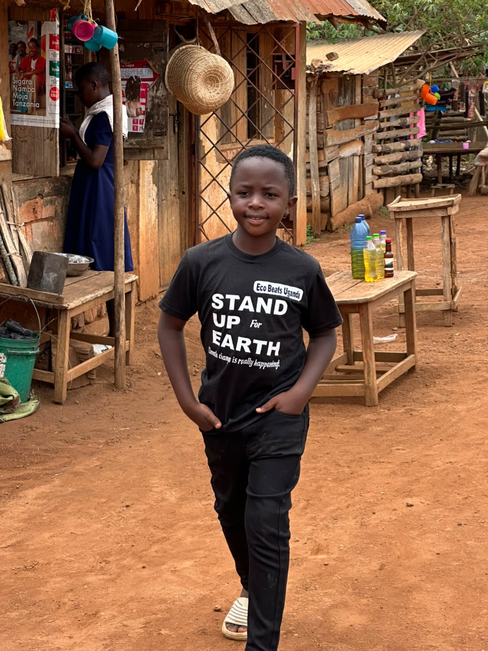 Prince wearing Eco Beats Uganda shirt in a village setting